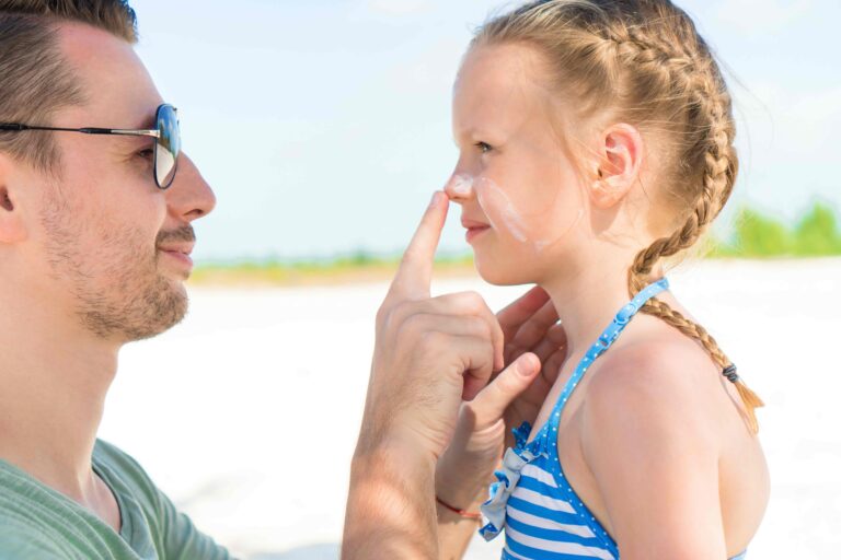 Parent,Applying,Sun,Cream,To,Kid,Nose