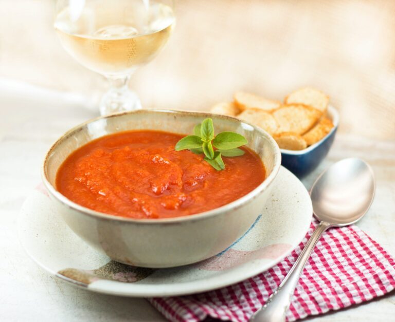Tomato soup bowl with wine and croutons