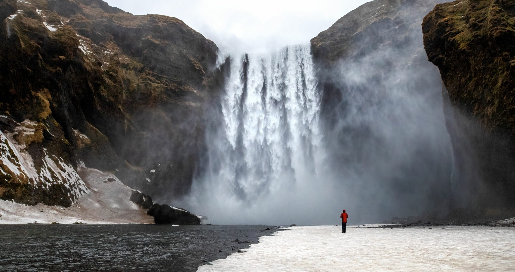 Skogafoss waterfall with solitary person
